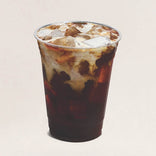 Clear plastic cup with iced coffee and cream on a beige background