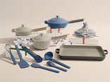Set of kitchen utensils and cookware with blue and gray colors on a beige background