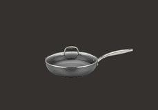 A gray nonstick frying pan with a glass lid and a metal handle, shown against a plain dark background.