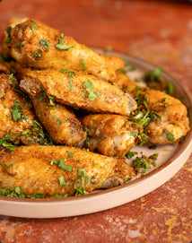 Baked chicken wings with herbs on a plate