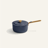 Blue saucepan with gold handle on a white background