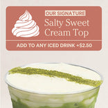Promotional sign for 'Salty Sweet Cream Top' on a drink with green and white layers.