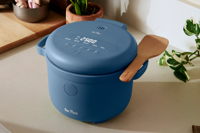 A blue Our Place rice cooker on a countertop