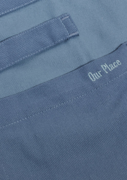 Close up of the detailing on the pocket of a blue Home Cook Apron