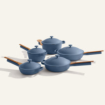 Set of blue cookware with wooden handles on a white background