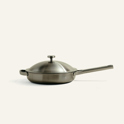 A stainless steel Titanium Always Pan Pro 10.5″ 2.0 skillet with a matching lid and a long handle.
