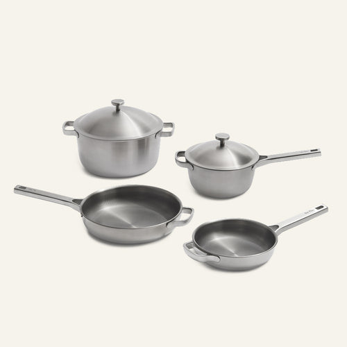 Two stainless steel saucepans with lids, a large frying pan, and a smaller frying pan from the Titanium Pro Cookware Set 2.0.