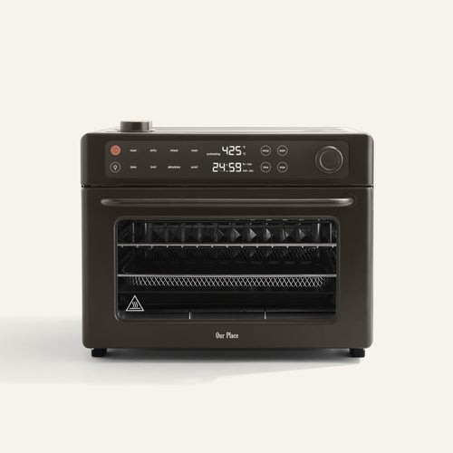 A countertop air fryer oven with a digital display showing 425°F and 24:59. The oven is dark-colored and has control knobs, buttons, and multiple internal racks.