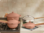 pink perfect pot and mini perfect pot on stove, pink mini always pan and chrome always pan pro on counter