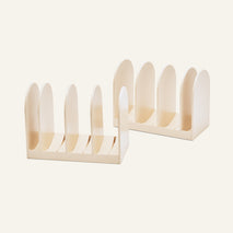 Two light-colored Universal Storage modular racks for cookware with rounded dividers.