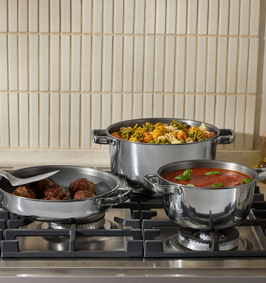 cooking meatballs, pasta, and sauce on stove with titanium always pan, titanium perfect pot and mini titanium perfect pot on stove