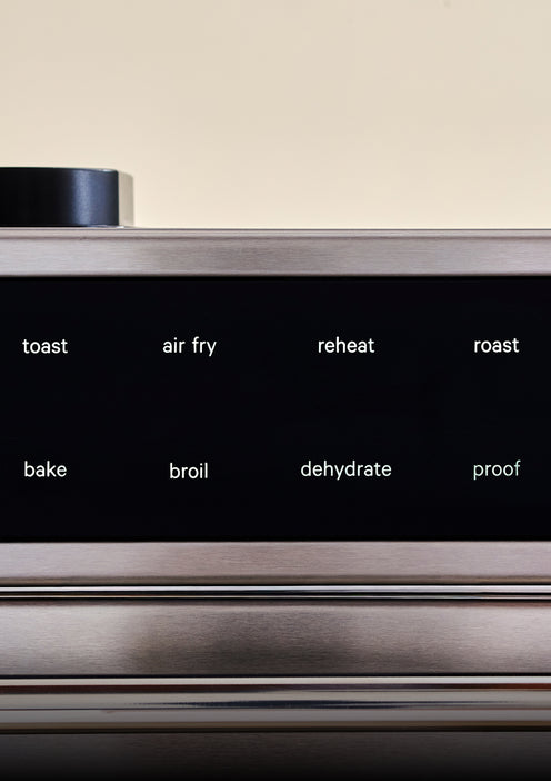 Stainless steel kitchen appliance with control panel displaying functions like toast, air fry, etc.