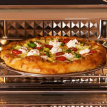 Pizza with various toppings baking in an oven