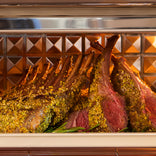 Roasted rack of lamb with herb crust on a decorative background