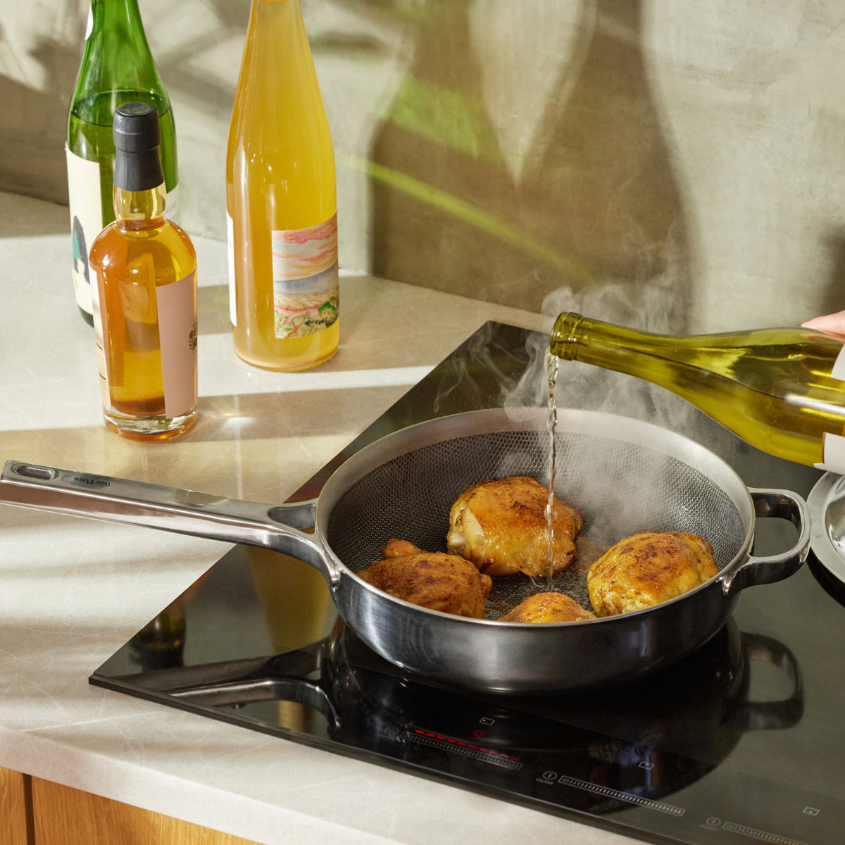 Deglazing a quick pan sauce in a chrome Titanium Always Pan Pro.