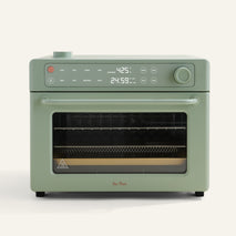 Green toaster oven with digital display on a white background