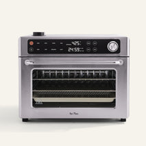 Stainless steel oven with digital display on a white background