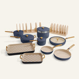 Set of blue and beige cookware with checkered trivets on a white background