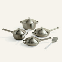 set of titanium pots and pans on white background